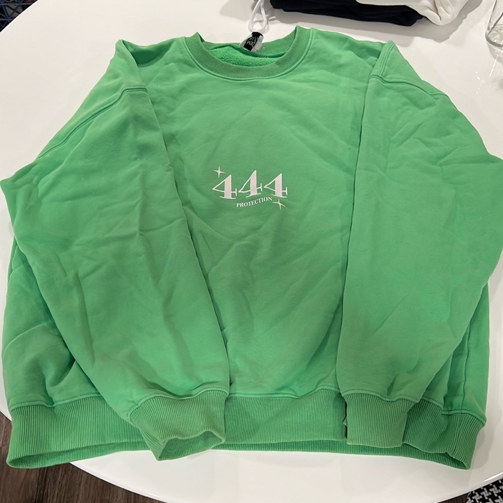 Oversized green sweatshirt with 444 protection decal